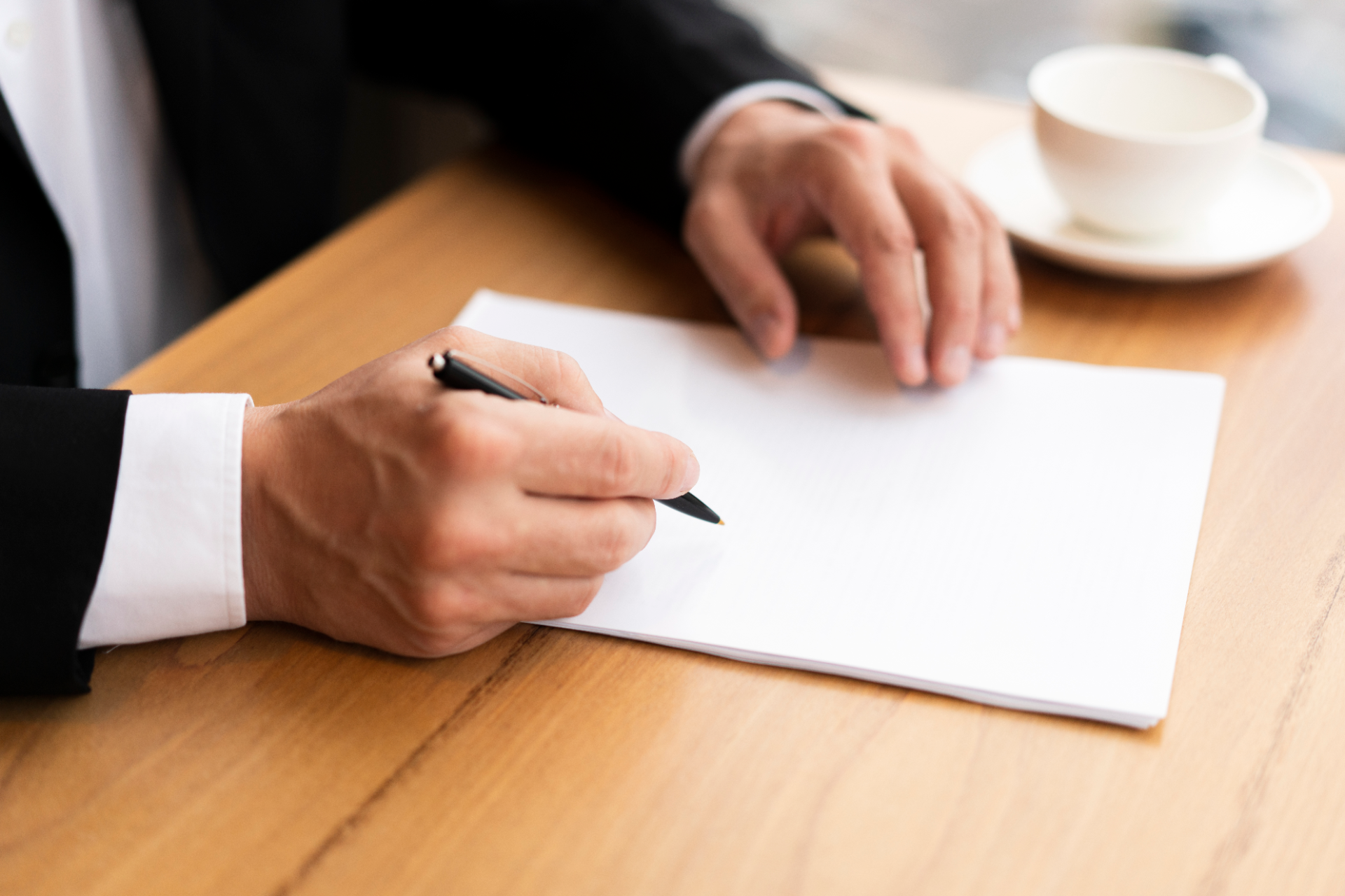 Une personne en costume signant un document